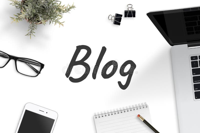 A white surface with the word "Blog" written in large, dark gray cursive letters. Surrounding the word are a laptop computer, a smartphone, eyeglasses, a small potted plant, two binder clips, and a spiral notebook with a pencil on top.